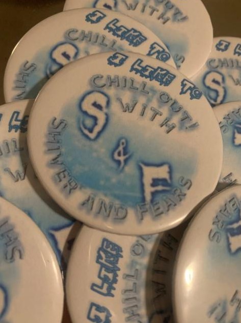 White buttons with the Shiver and Fears logo